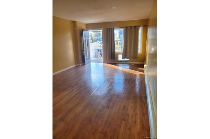 Empty room featuring dark wood-type flooring