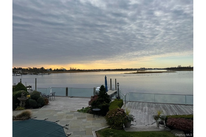 View of patio / terrace featuring a boat dock and a water view