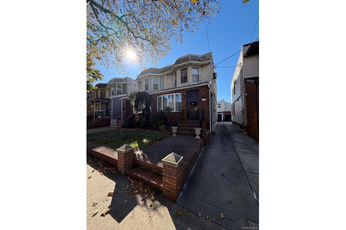 View of front facade featuring brick siding and a patio