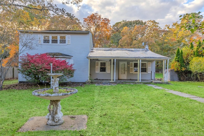 Traditional-style home featuring a chimney and a porch