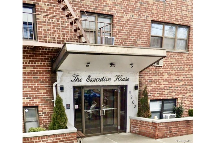 Doorway to property with brick siding and french doors
