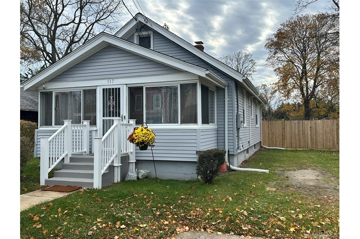 Bungalow-style house with a sunroom and a chimney
