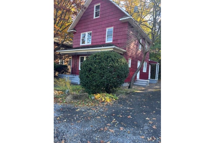 View of side of property with a porch