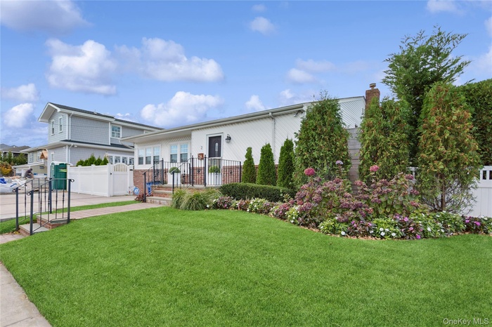 View of front of home with a chimney and a gate