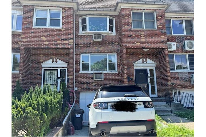 View of front of home featuring brick siding
