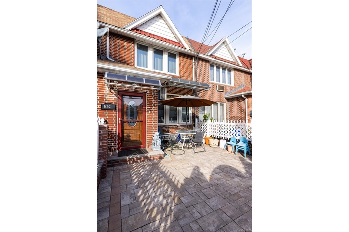 Rear view of house featuring a patio and brick siding