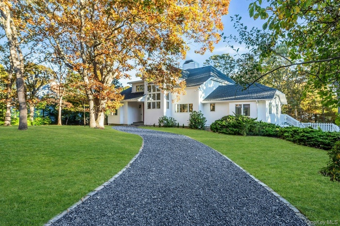 View of front of home with a front lawn and stucco siding