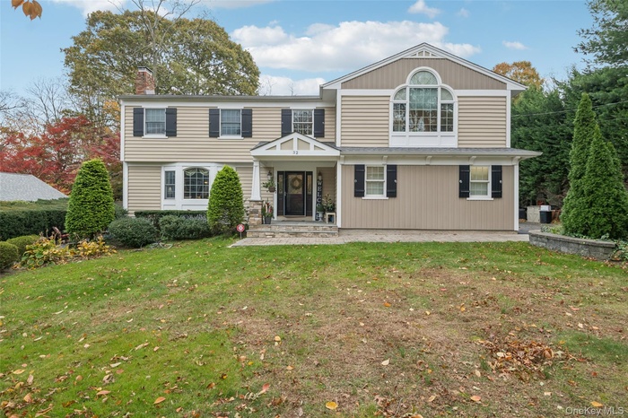 Set on 1/2 acre with inground poo. lViewof front of property featuring a chimney and a front yard