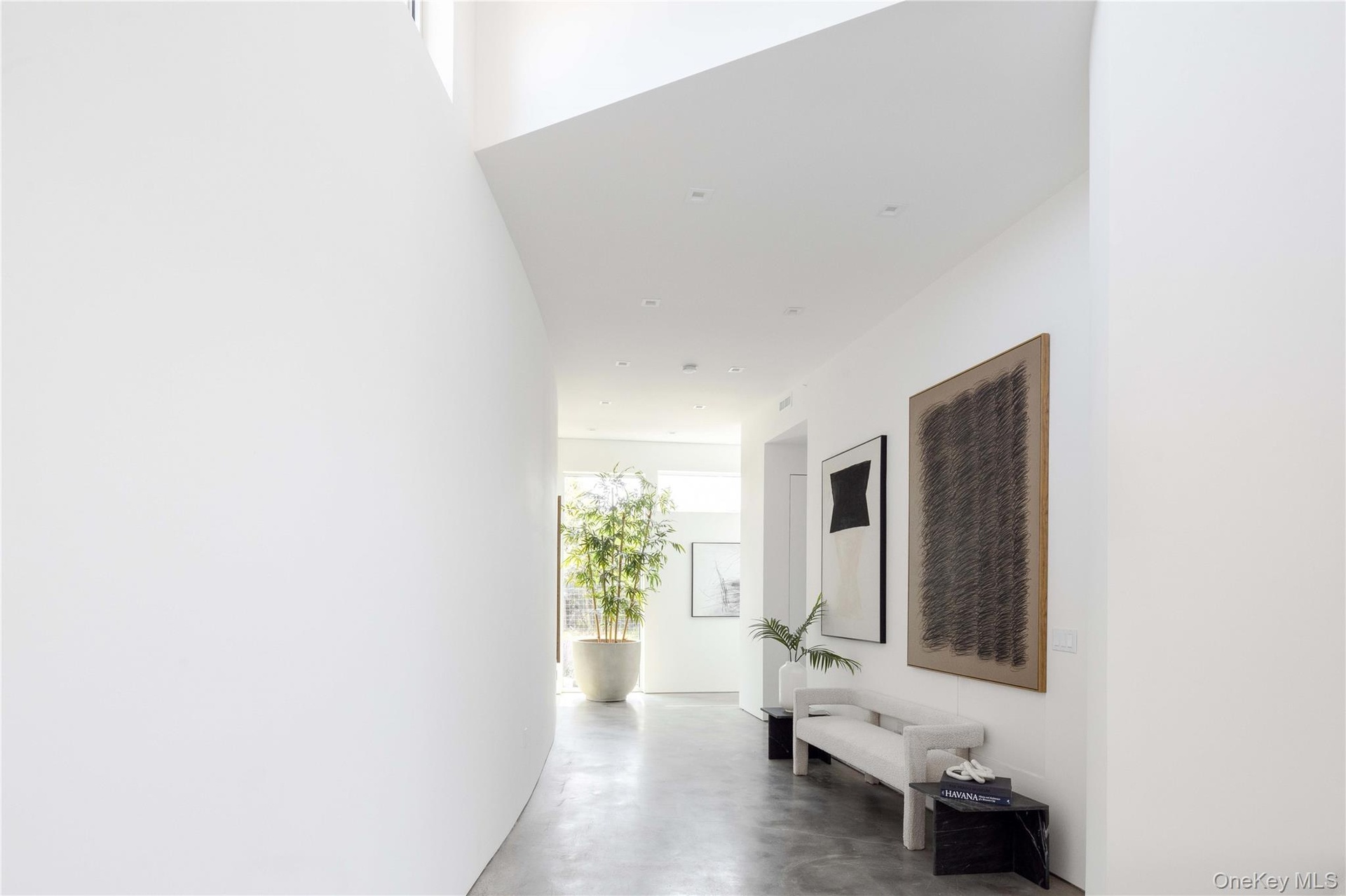 Hallway featuring concrete flooring
