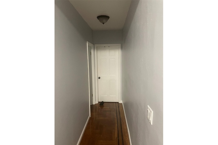 Corridor featuring baseboards