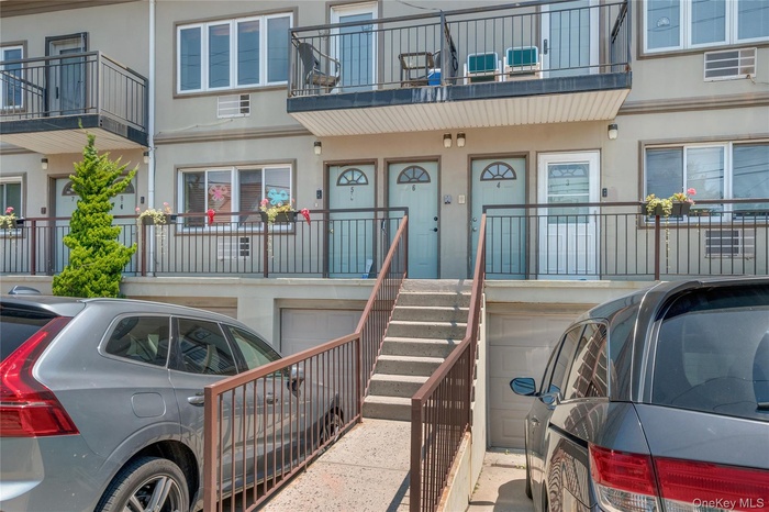 Entrance to property featuring stucco siding and a garage