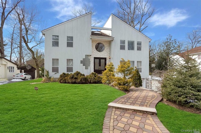 View of front of house with stone siding and a gate