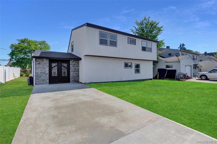 View of front facade with concrete driveway