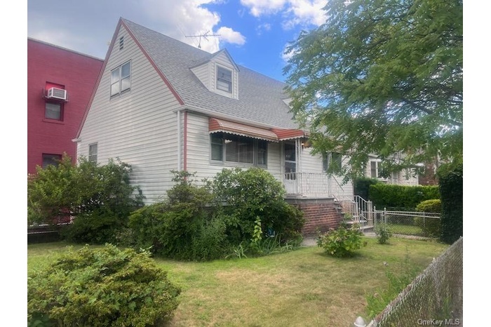 View of home's exterior featuring roof with shingles and covered porch
