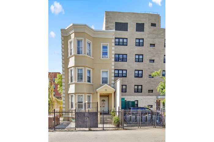 View of apartment building / complex featuring a fenced front yard