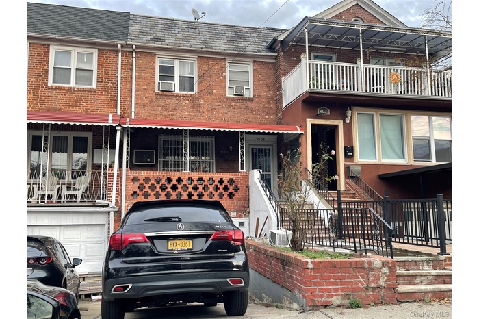 Traditional-style home with brick siding and a balcony