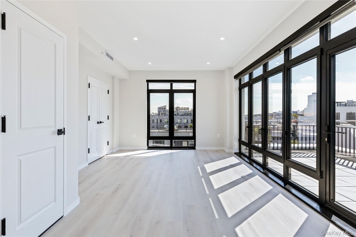 Spare room with recessed lighting, light wood-type flooring, and a city view