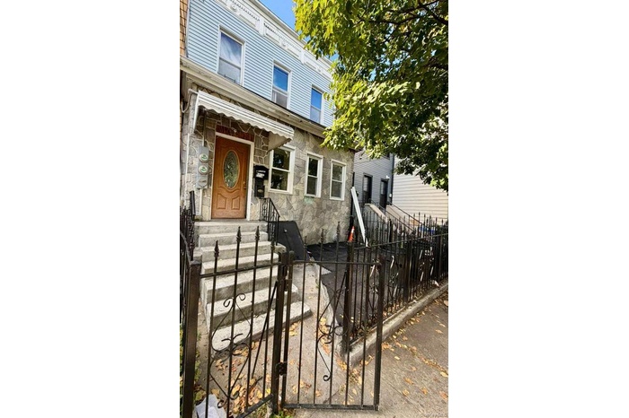 Italianate home featuring stone siding