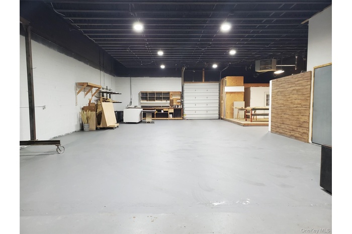 Below grade area with refrigerator and a garage