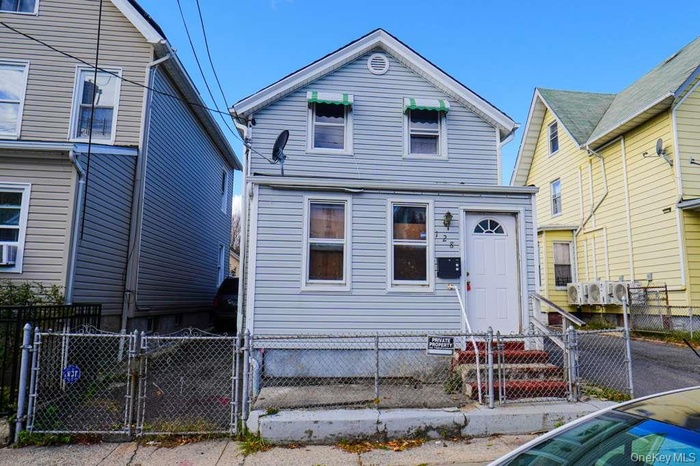 View of front of property with a gate and a fenced front yard