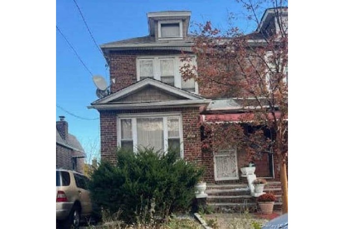 American foursquare style home with brick siding