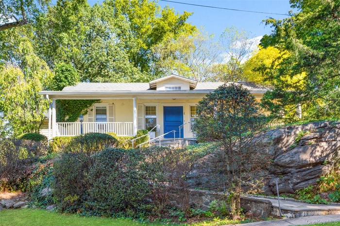 Bungalow featuring covered porch and stairs