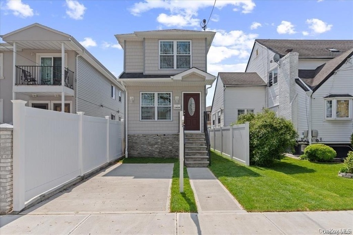 View of front facade featuring stone siding