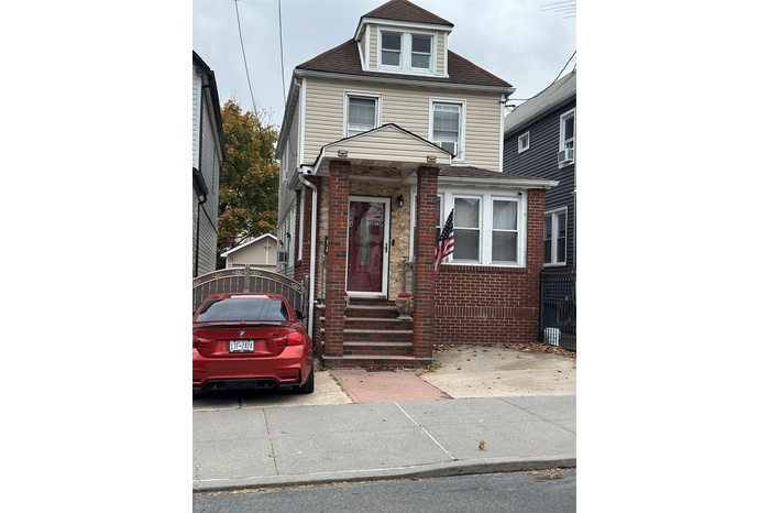 Traditional style home with brick siding and a shingled roof