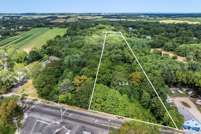 Aerial view of sparsely populated area with property parcel outlined