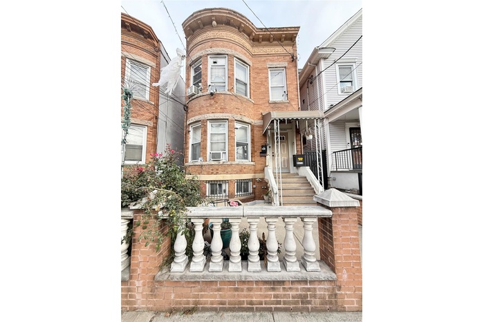 View of front of home featuring brick siding