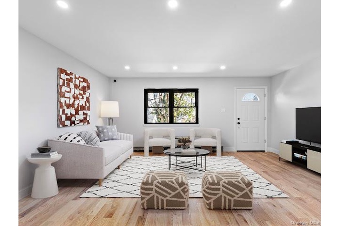 Living area featuring light wood-type flooring and recessed lighting
