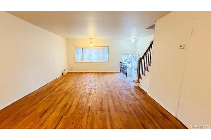 living room featuring stairs and wood finished floors