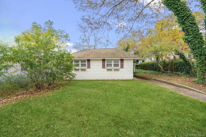 View of side of home featuring a lawn