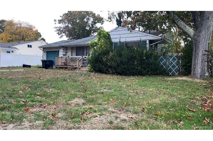 View of yard with a deck and an attached garage