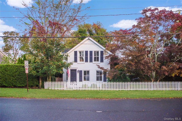 Traditional home with a fenced front yard