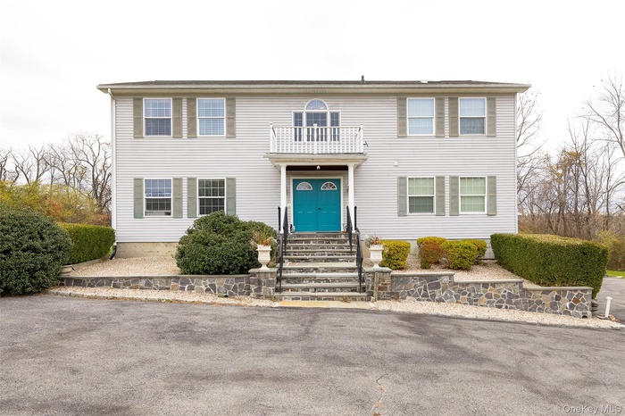 Colonial inspired home front balcony landscaped