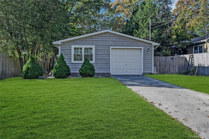 Garage featuring asphalt driveway