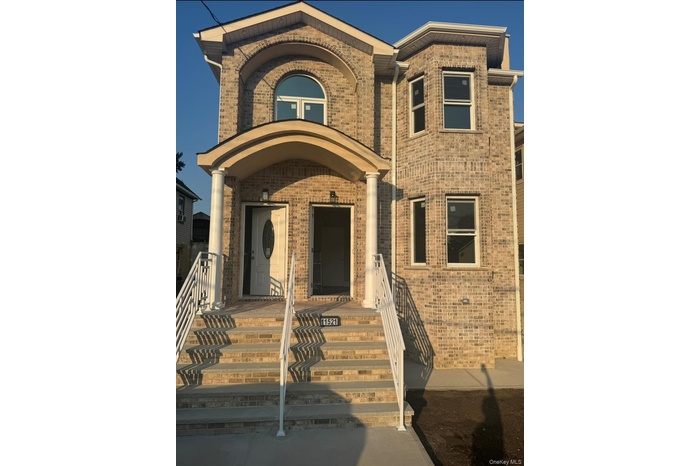 Doorway to property with brick siding