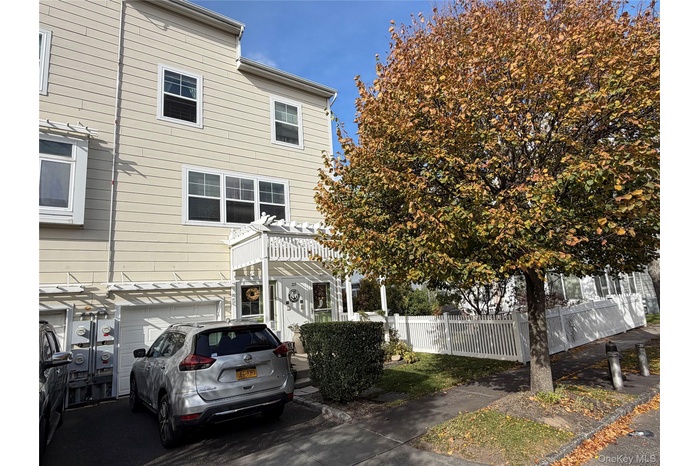 View of front of property featuring a garage and driveway
