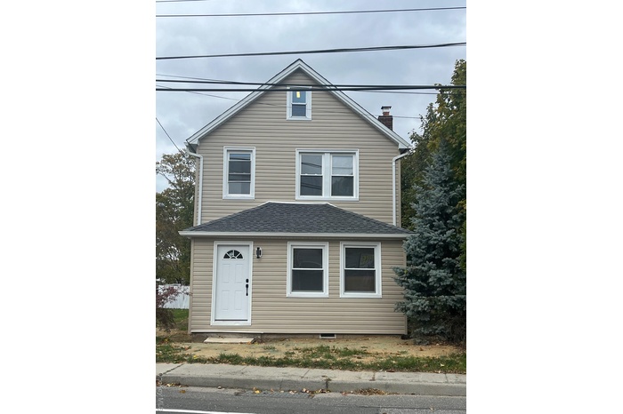 View of front of property with roof with shingles and a chimney