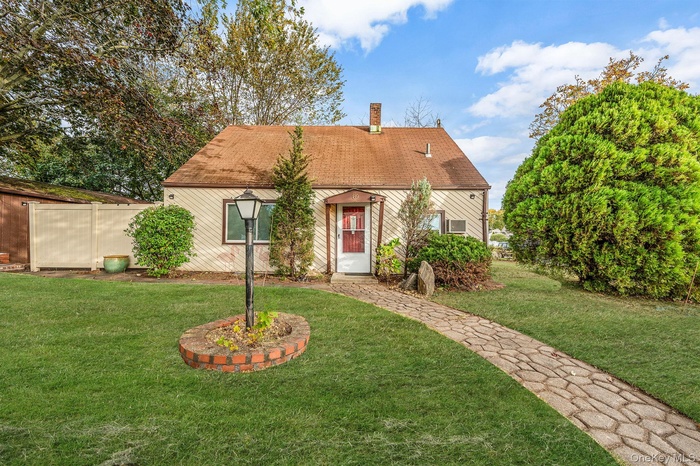 View of front of home with a front lawn and a chimney