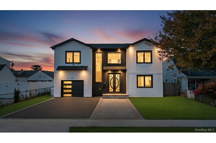 View of front facade with driveway and a garage