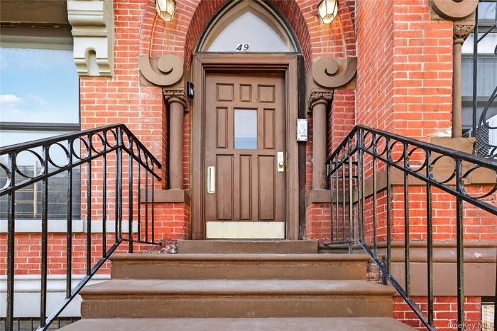 Entrance to property with brick siding