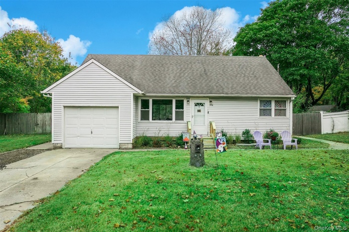 Ranch-style home with concrete driveway, an attached garage, and roof with shingles