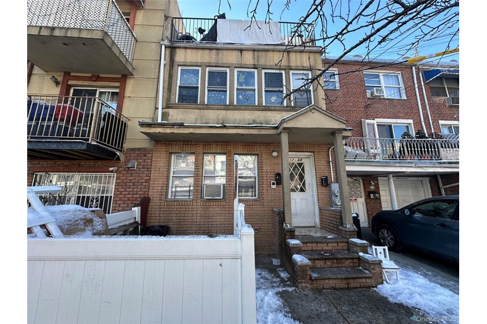 Traditional-style house featuring brick siding and a balcony