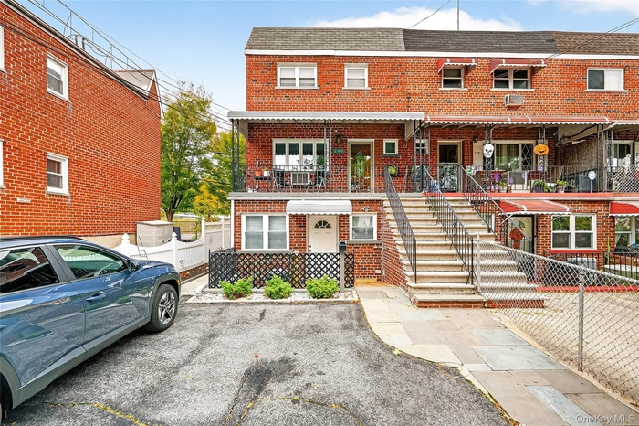 Traditional home featuring brick siding and roof with shingles