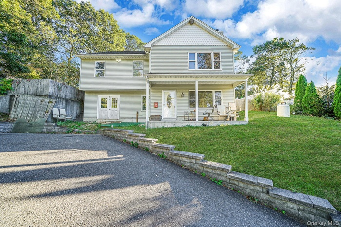 View of front of property featuring a front yard and a porch