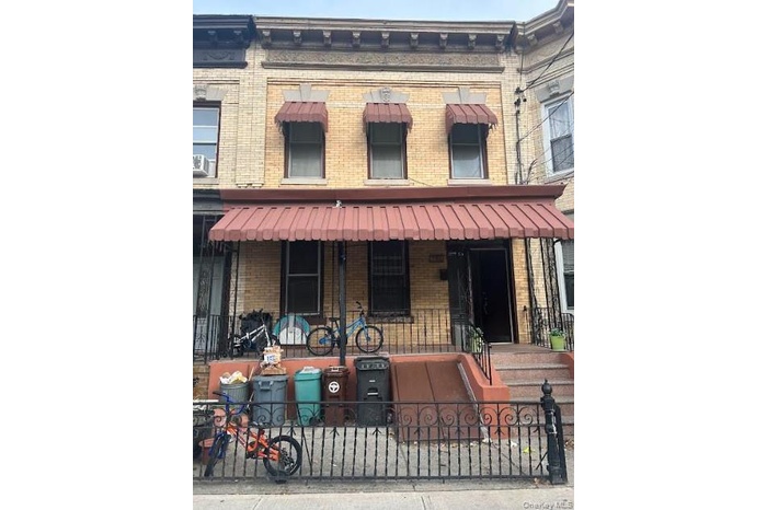 View of front of home featuring brick siding and a porch