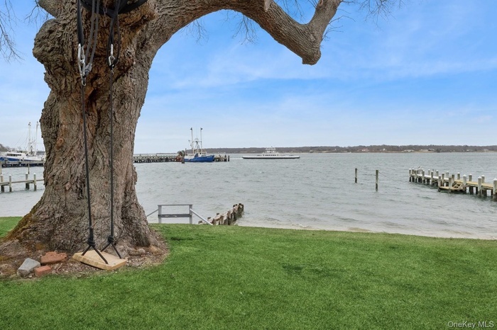 View of dock featuring a water view and a yard