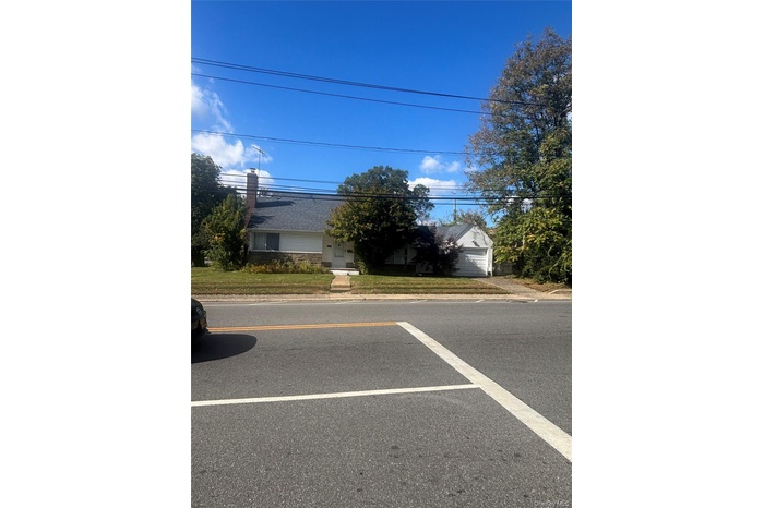 View of asphalt road featuring curbs